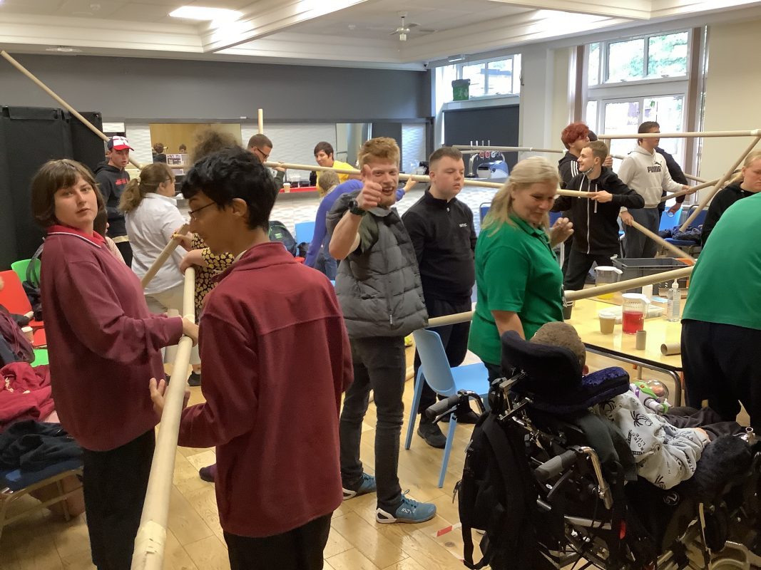 Room full of people completing a team building activity