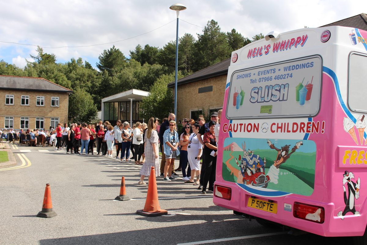 An ice cream van and large queue