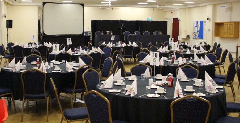 Conference room with round tables and stage and projector