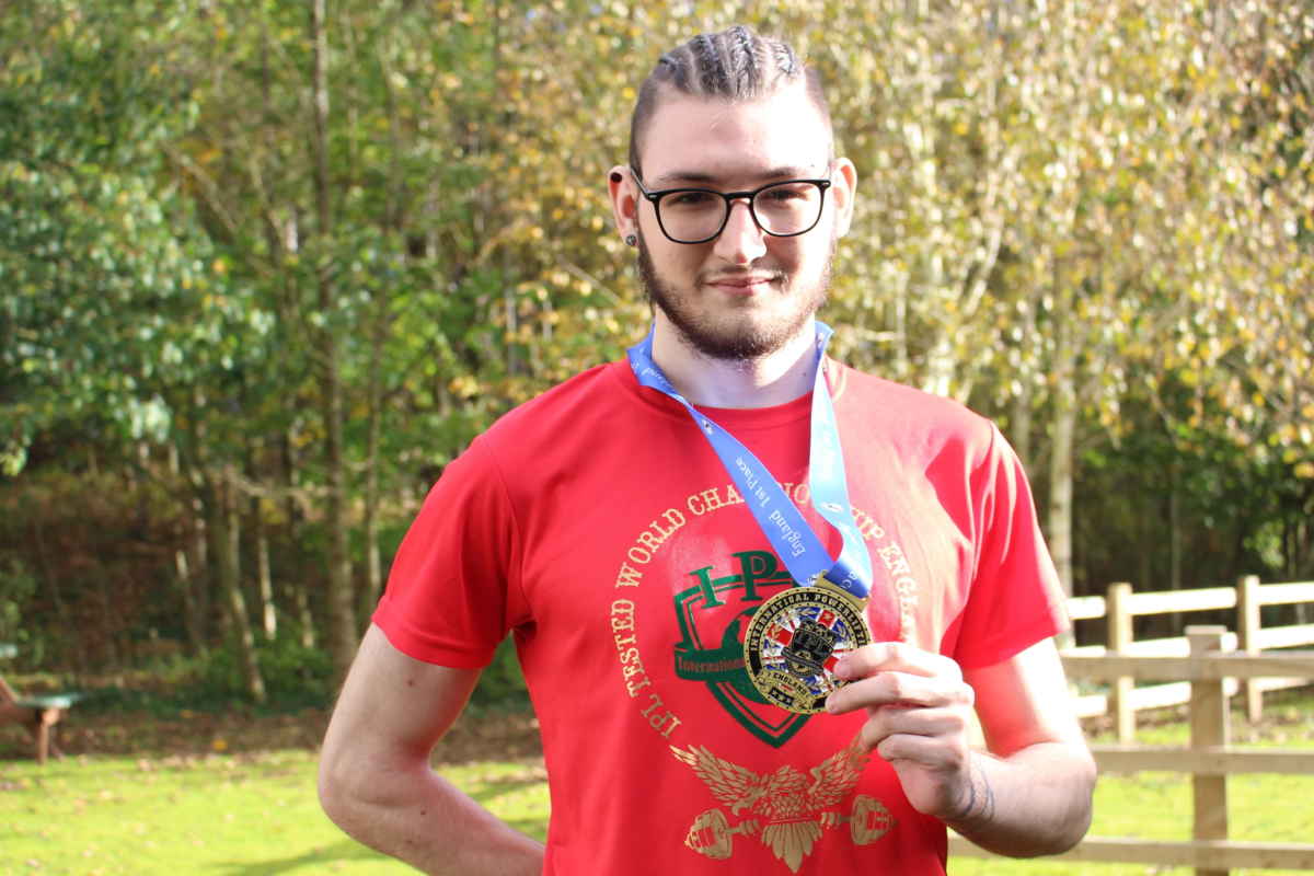 Learner David Stroughton holding his World Champion medal