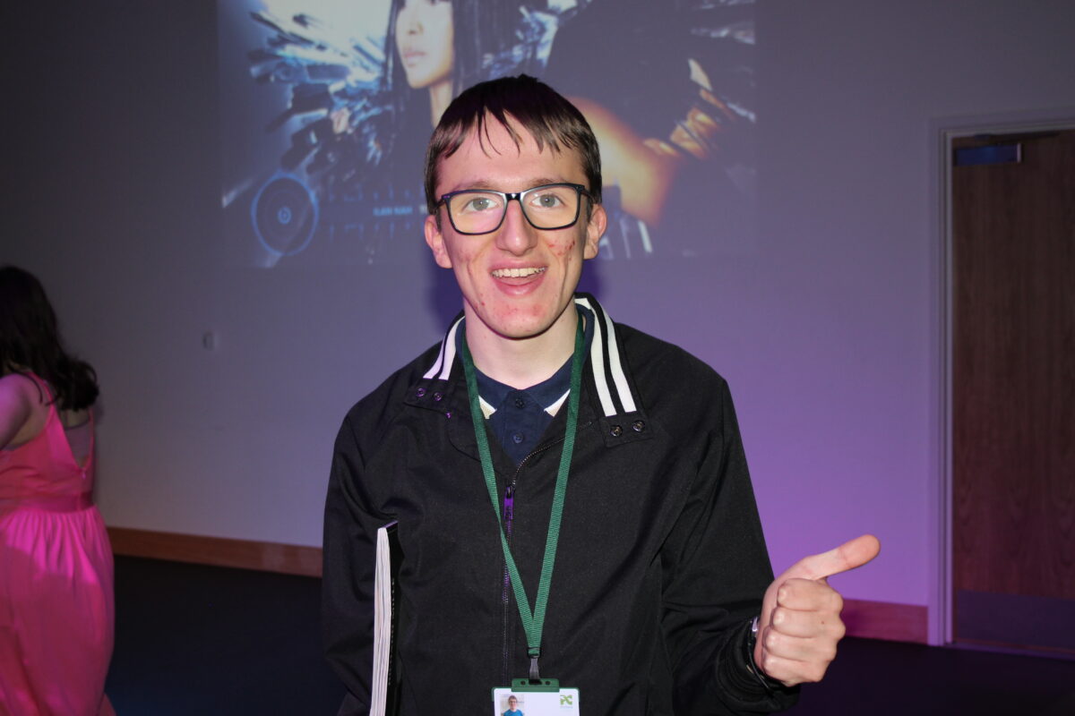 Image of a young man with glasses smiling with his thumb up