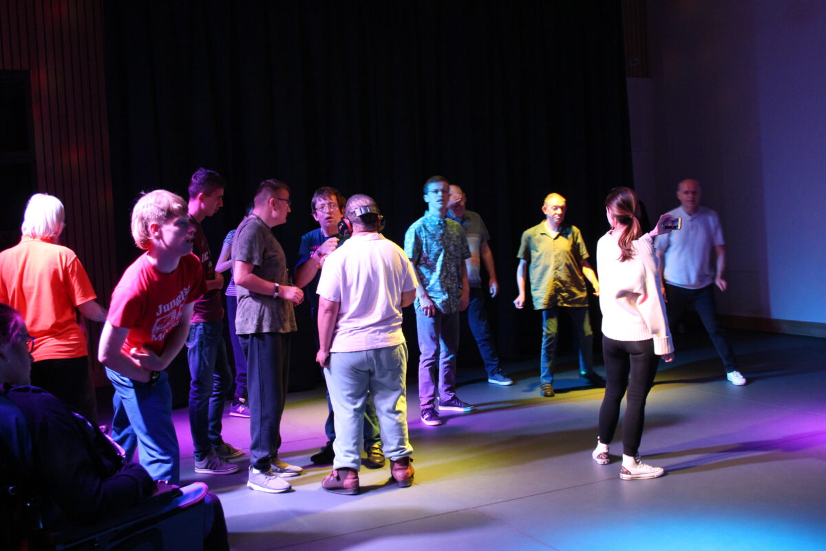 Image of a crowd of people on a dance floor with disco lights