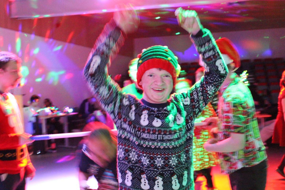 Smiling participant in an elf hat