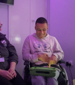 Dominic, a Media, Performance and Art student, uses an iPad with the Grid for iPad communication app during a learning session to support his communication and build independence.