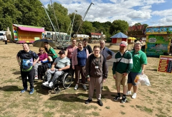 a group of citizens and staff at a fun fair