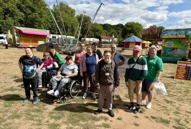 a group of citizens and staff at a fun fair